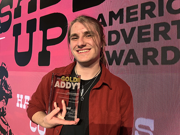 M State graphic design student Damon Lanoue with his Gold Addy plaque.