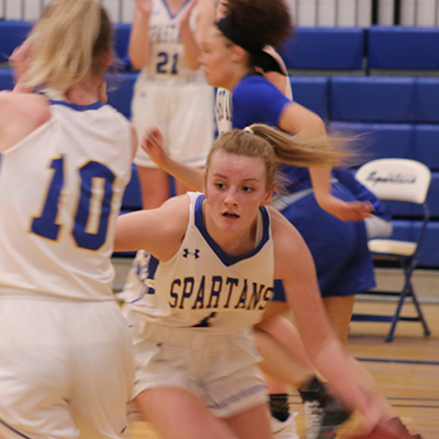 An M State basketball player moves down the court