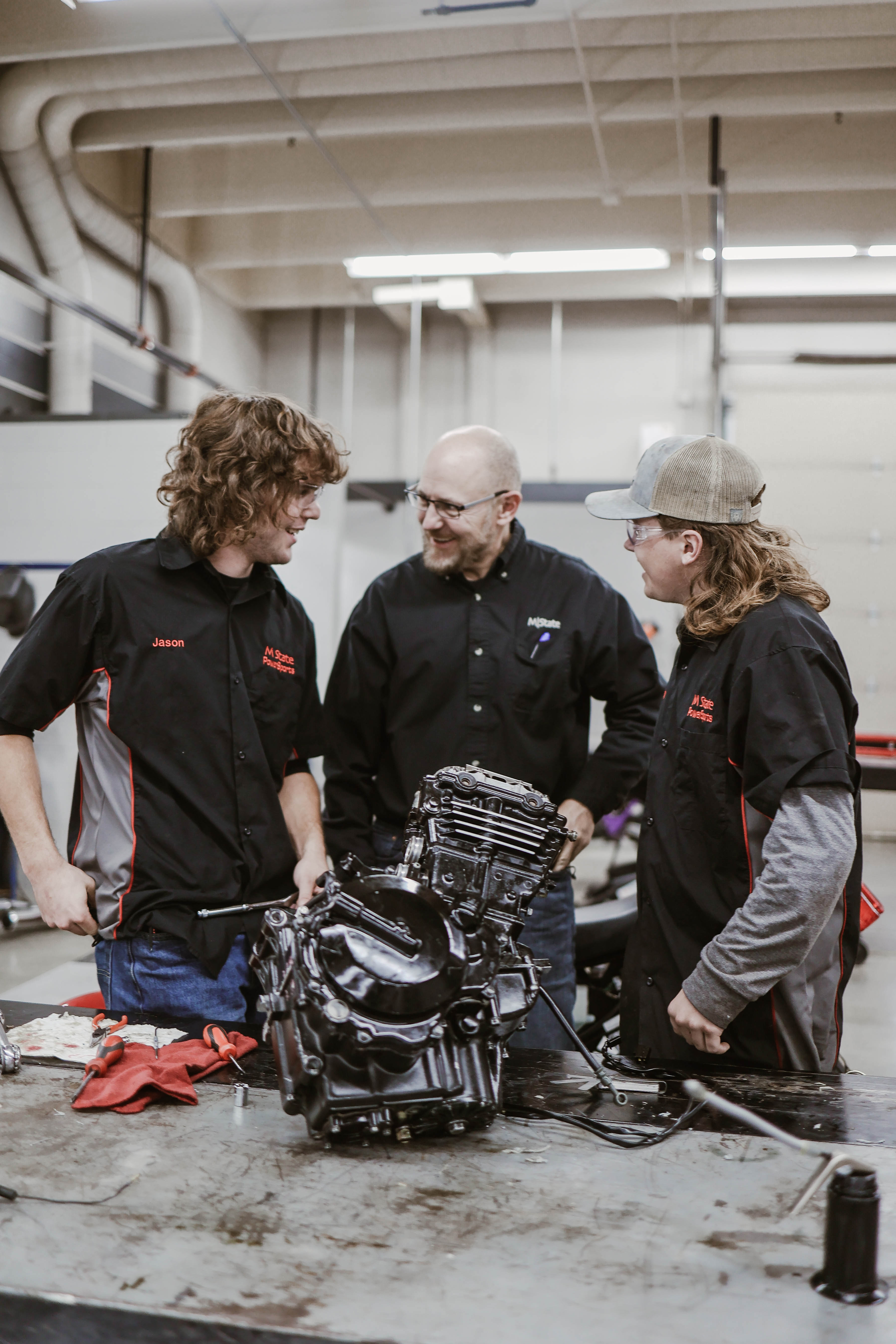 PowerSports instructor Kent Reisenauer, center, laughs with two students during a class in the early 2020s.
