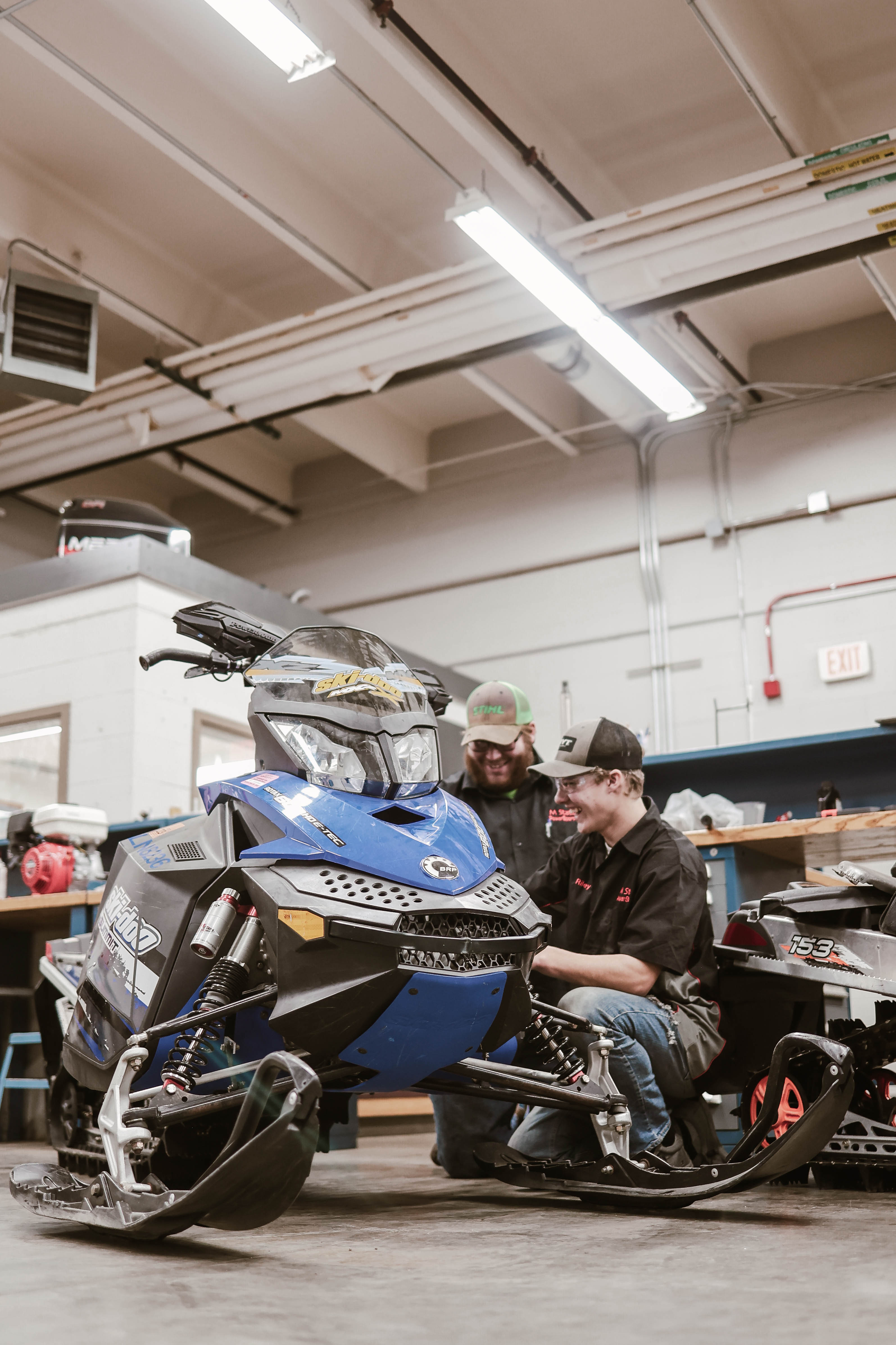 Students in the PowerSports Technology program work on a snowmobile in the early 2000s..