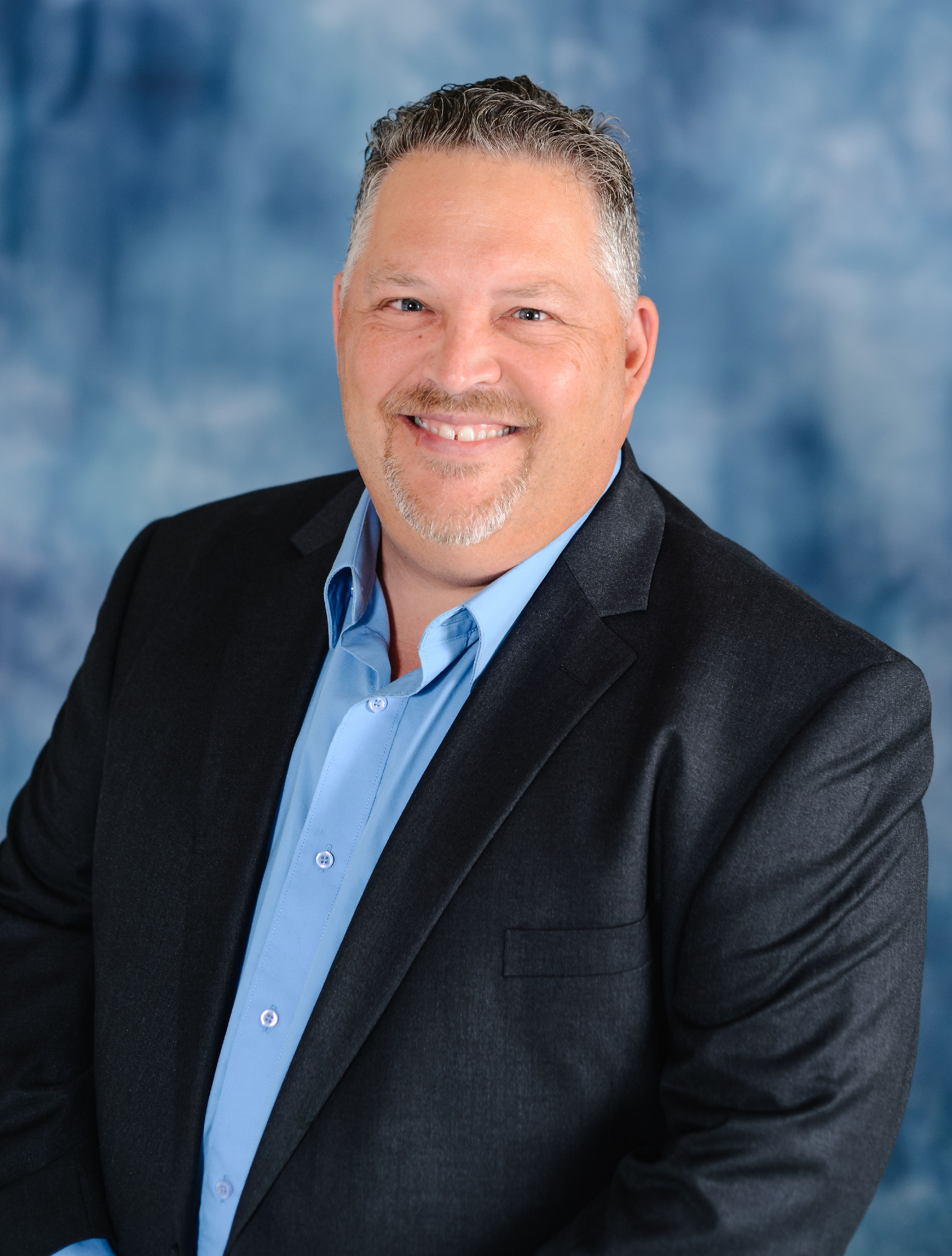 Marcus Lacher, portrait in front of blue background