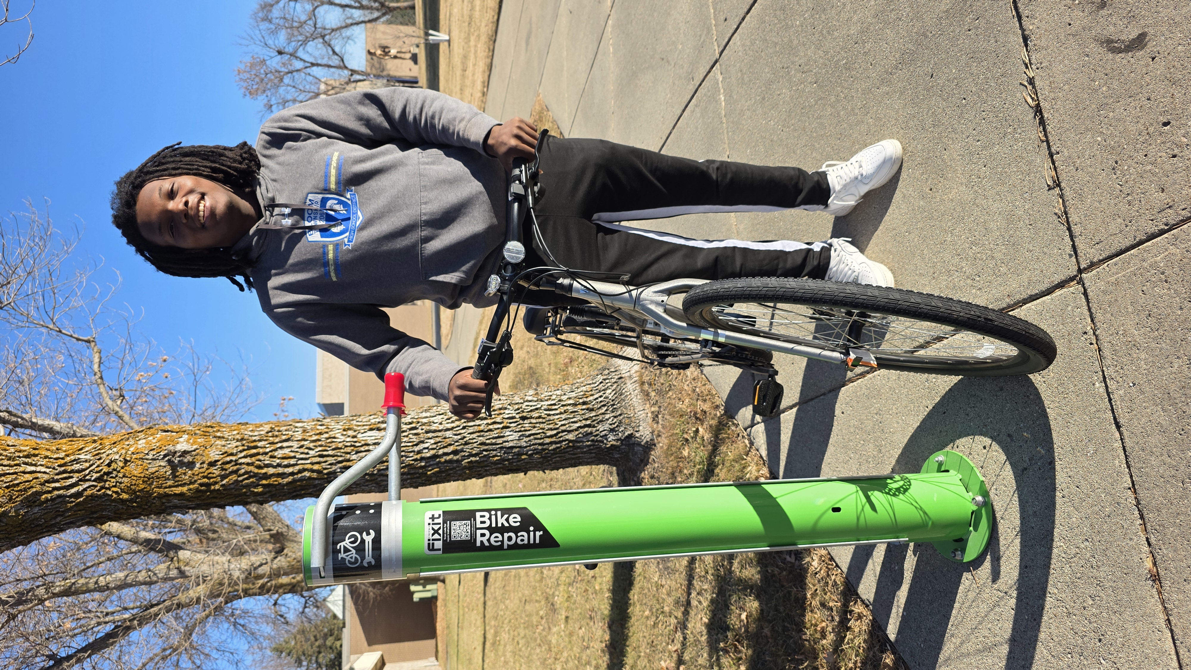 M State Fergus Falls student Makarri Galloway, with his bike at the new, free bike repair station on campus. Galloway, who's from Chicago Heights, Illinois, is one of many students who rely on biking to get around campus. 