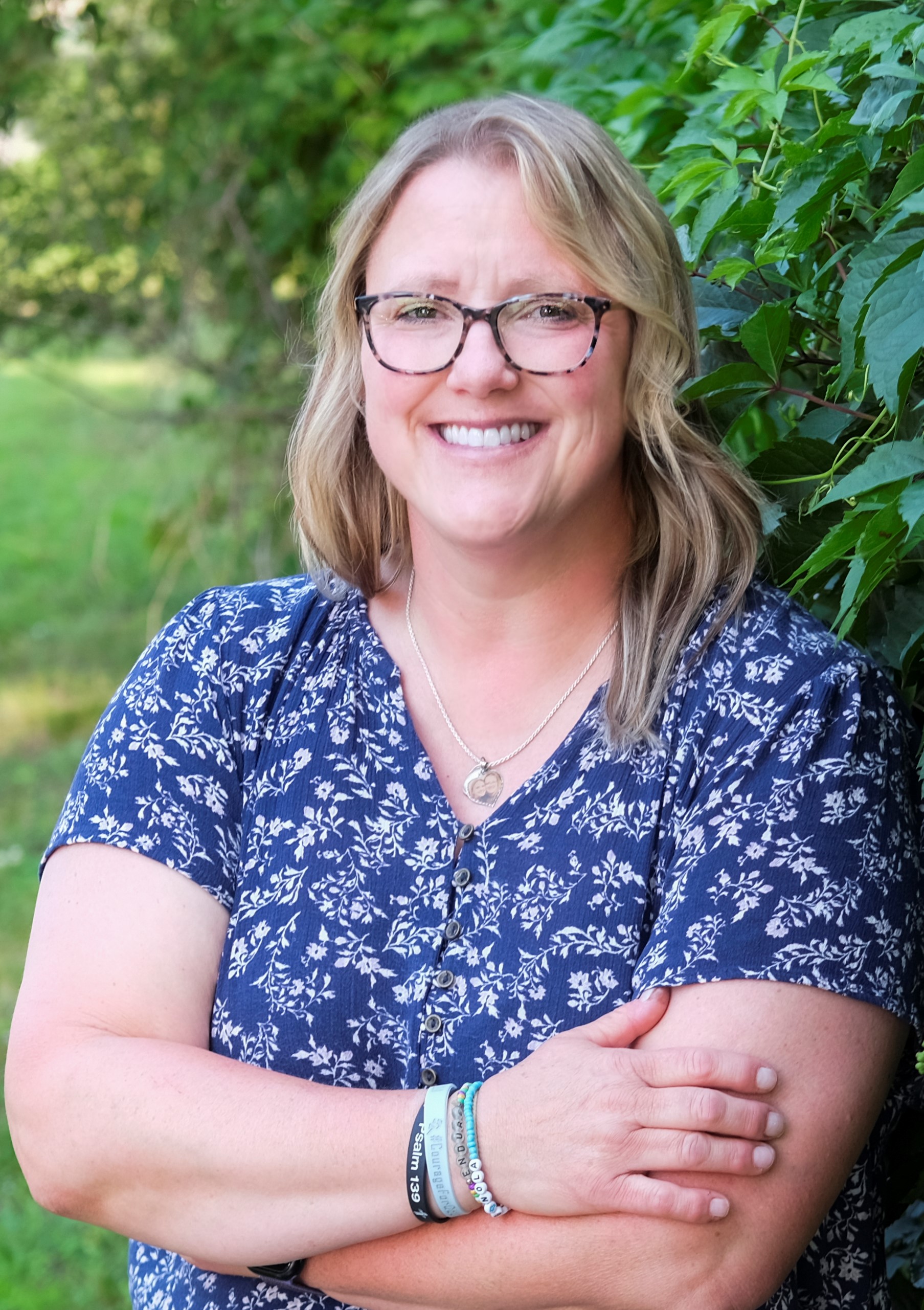 Mara Ieselniaks, portrait in front of green shrubbery