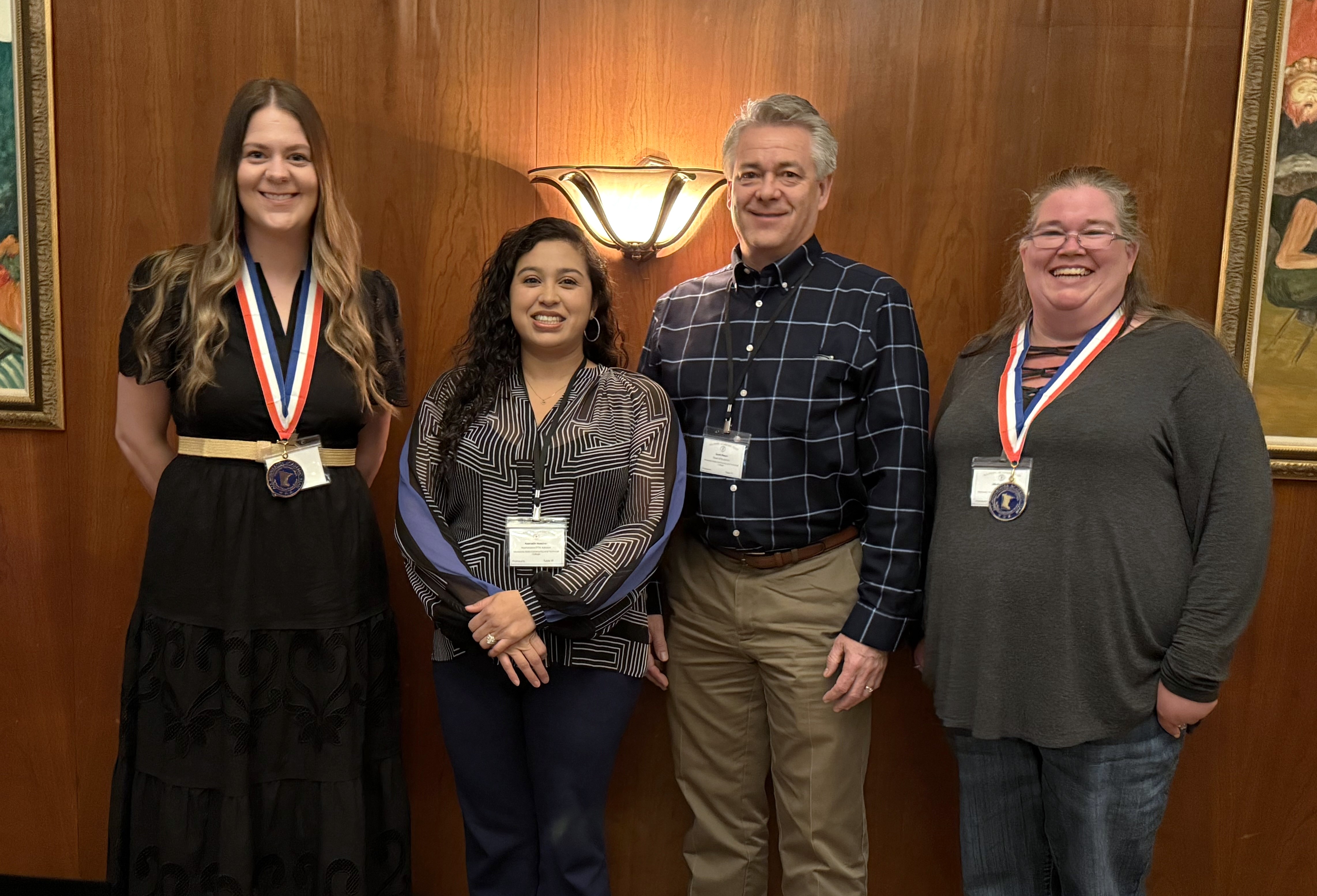 M State PTK All-Minnesota Academic Team honorees Leah Kunde, far left, and Nicole Sorby, far right, with chapter advisor Asenath Huether and Dean of Student Affairs Scott Ebsen at the PTK luncheon in April 2026.