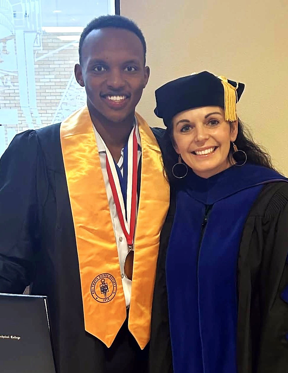 M State President Carrie Brimhall, with M State graduate and PTK student Joseph Mugisha, at the 2023 graduation ceremony in Moorhead.