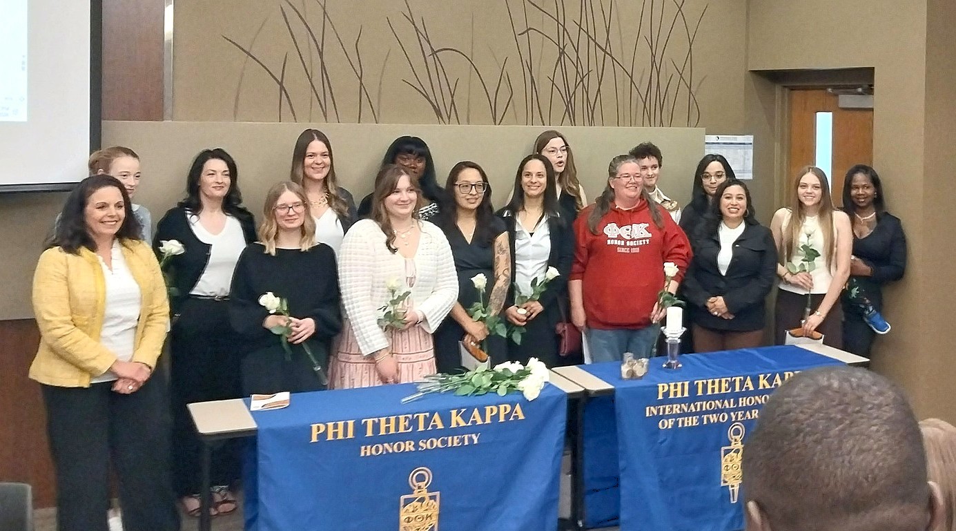 A group of about 15 recent M State PTK honor society inductees pose for a picture with M State President Carrie Brimhall and PTK chapter leaders at the 2026 induction ceremony at M State Moorhead.