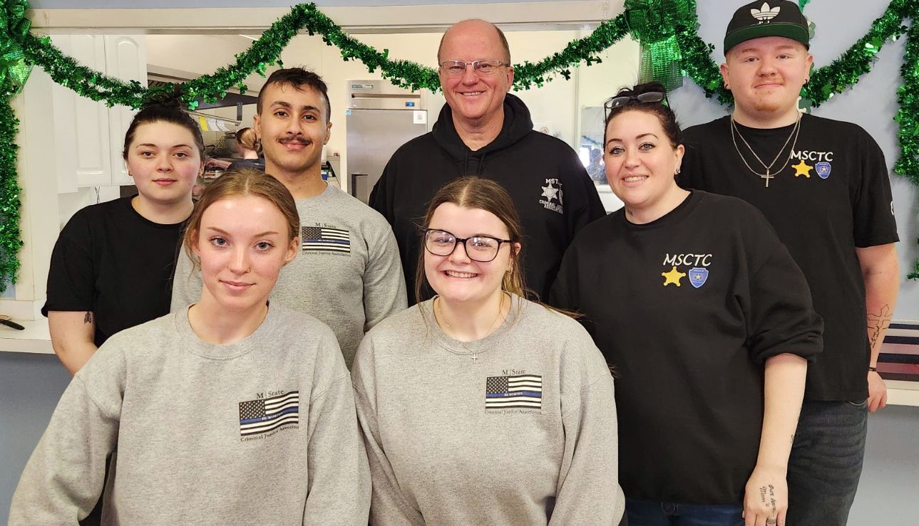 M State Criminal Justice Program Coordinator and Faculty member Jeff Nelson, standing, center, with Criminal Justice program participants Lily Tesla, Binyad Brifki, Lacey Tesla and Jace Tesla, standing, left to right, and Briana Mitchell and Tristan Altepeter, in front.