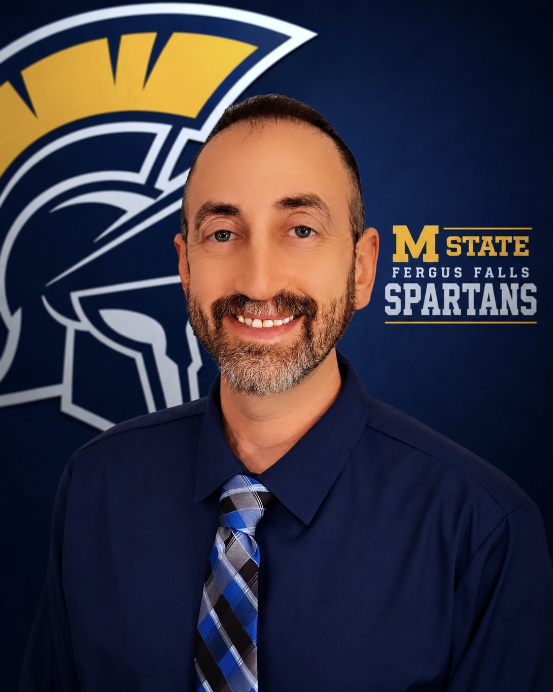 Steve Schreiber, professional head shot in front of a Spartans logo