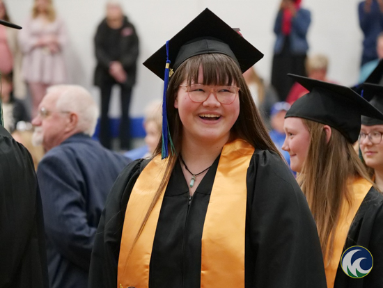 an M State grad poses for the camera