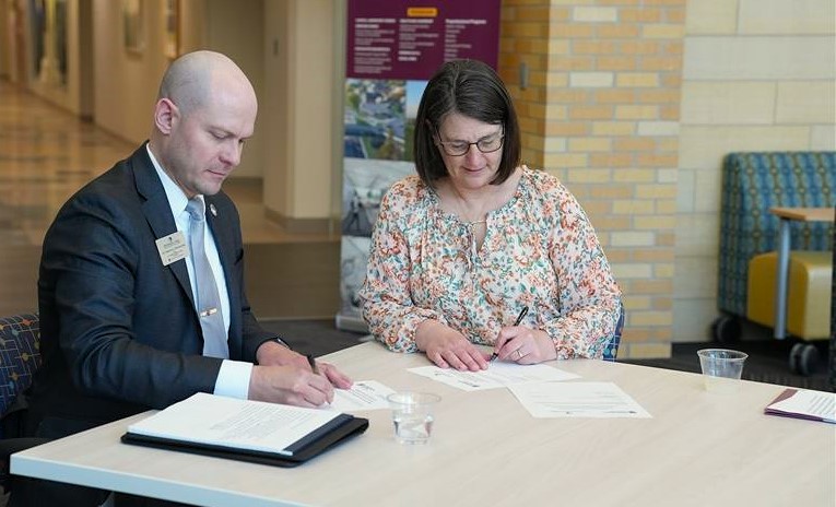 Matt Borcherding and Susan Larson sign articulation agreements between M State and Concordia College