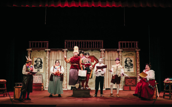 a group of people on stage in costumes