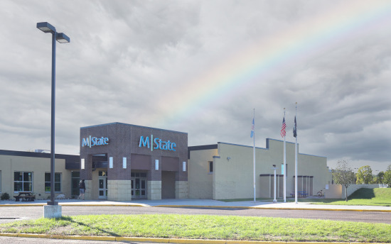 A photo of the exterior of M State-Wadena with a rainbow occurring over the building