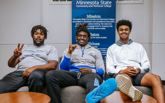 Photo of three student athletes hanging out in one of the lounge spaces