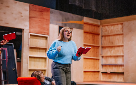 a person is reading in front of a group of people