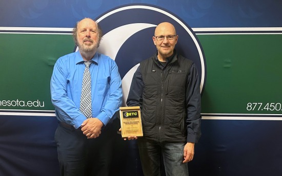 Dr. Mark Bannatyne and Kent Reisenauer, with the PowerSports Technology 2024 College of the Year award from EETC