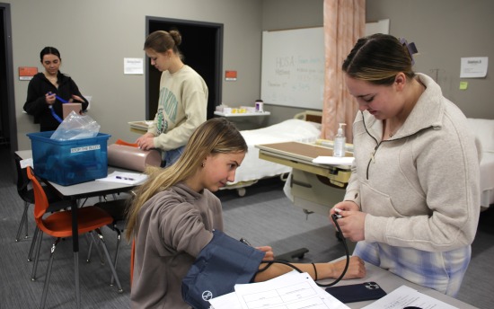 Students practice their blood pressure-checking skills in an emergency responder course at Moorhead High School Career Academy in November 2024.