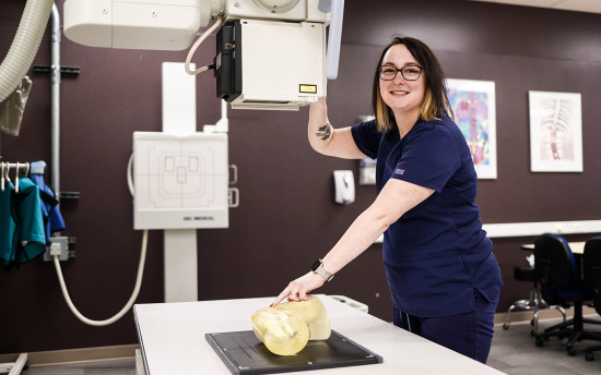 A student positions a bone model for an x-ray