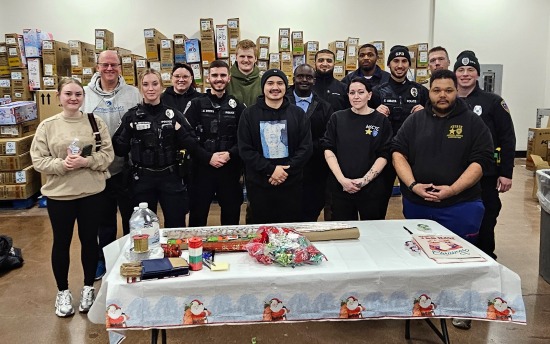 Past and present M State Criminal Justice students, at the Dilworth Walmart, wrapping gifts as part of the 'Shop With a Cop' holiday shopping event.