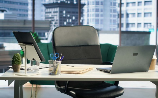 A modern office setting with desk and laptop