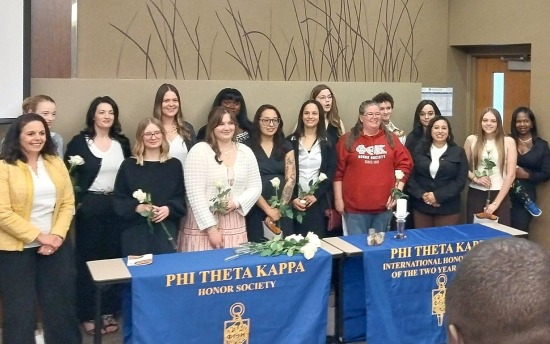About 15 M State PTK students pose for a picture with college president Carrie Brimhall and PTK chapter advisors during the 2026 induction ceremony on the Moorhead campus.