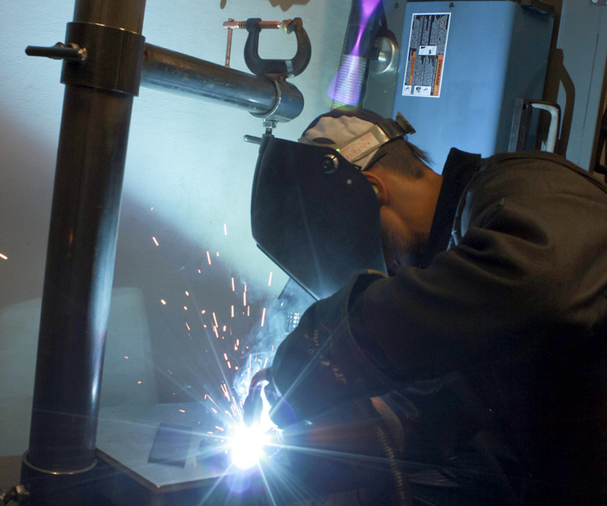 A welder works in M State's mobile welding training truck