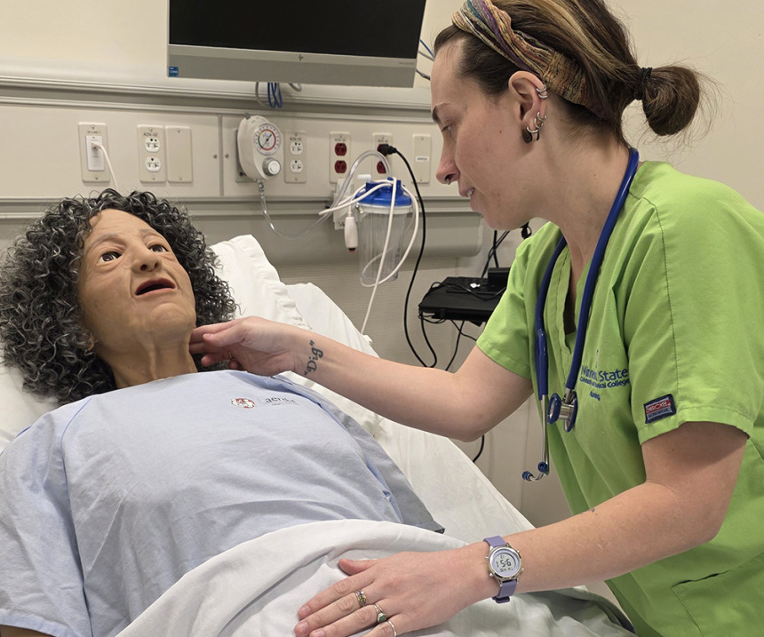 A student works on a simulation center manikin