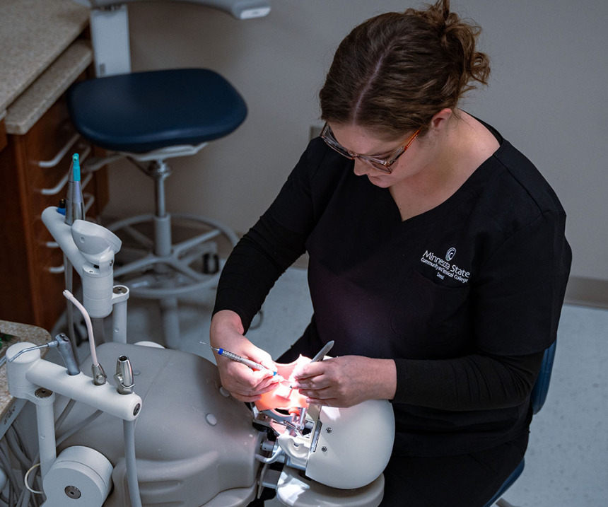 A student works on a model in the dental simulation lab
