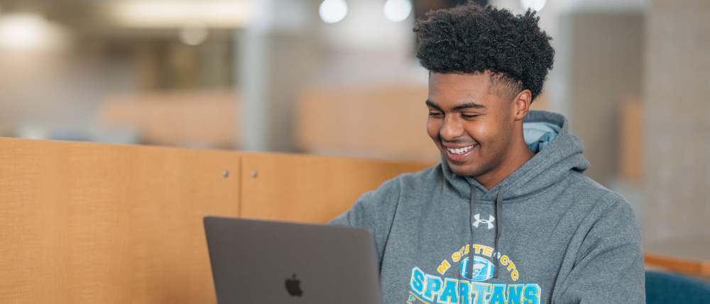 A student works at a laptop
