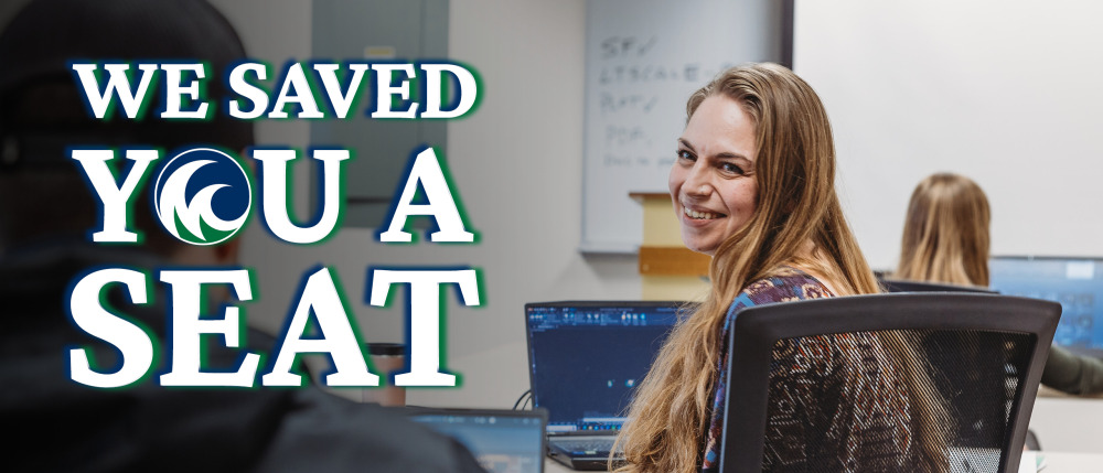 woman smiling looking over her shoulder at another student with the words "We saved you a seat".