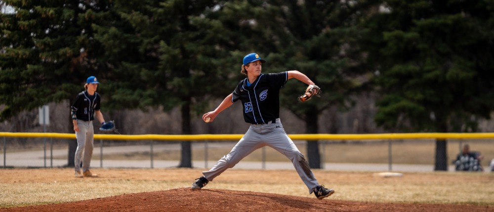 An M State pitcher winds up