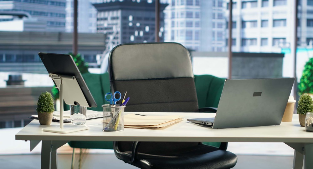 A modern office setting with desk and laptop