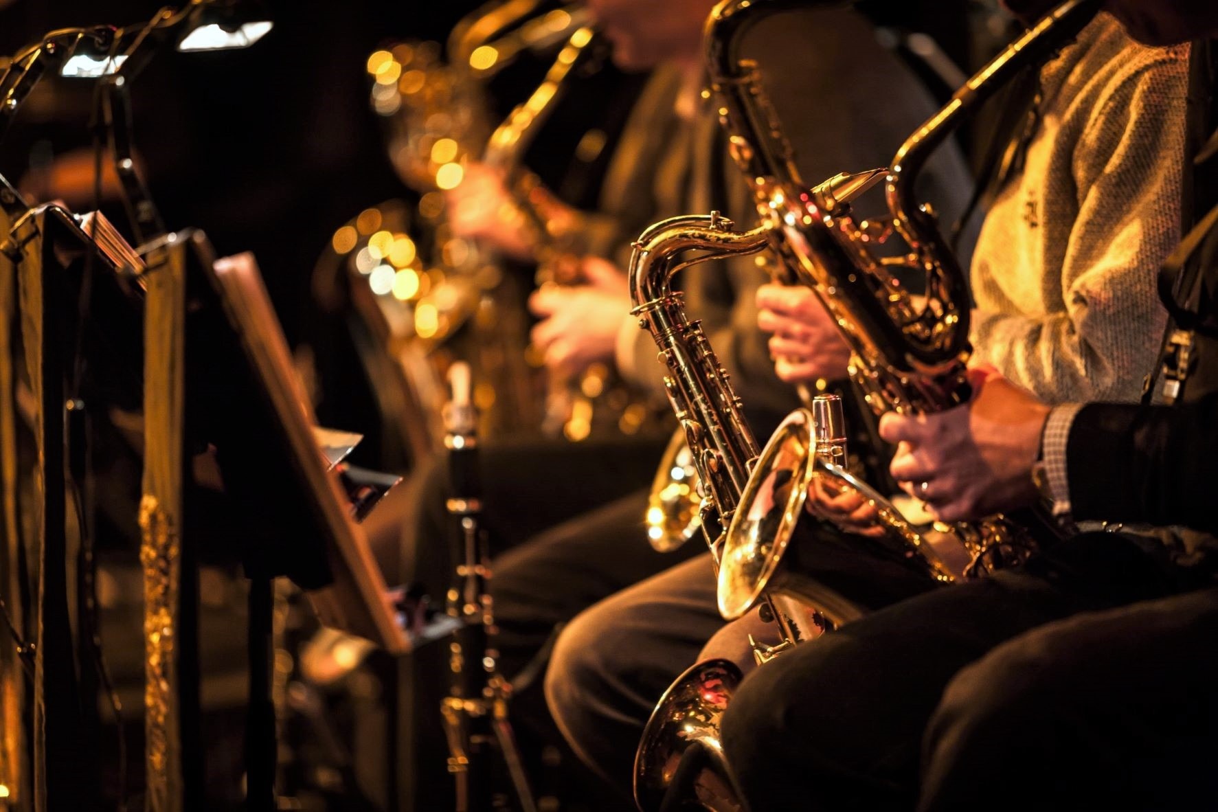 A row of saxophones and other instruments.