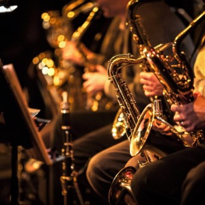 A row of saxophones and other instruments.